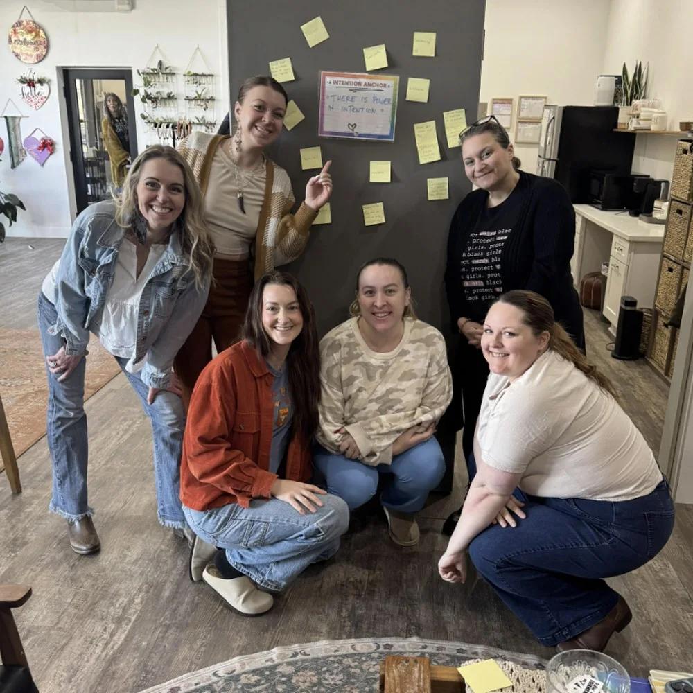 Jill Reed and the Raw Hair Society team gathered around their shared intention board in Corvallis, Oregon